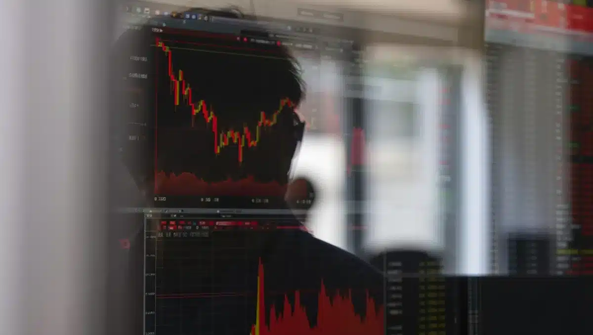 Stock market screen displaying red downward indicators and financial charts with candlestick patterns descending | stock market decline screen
