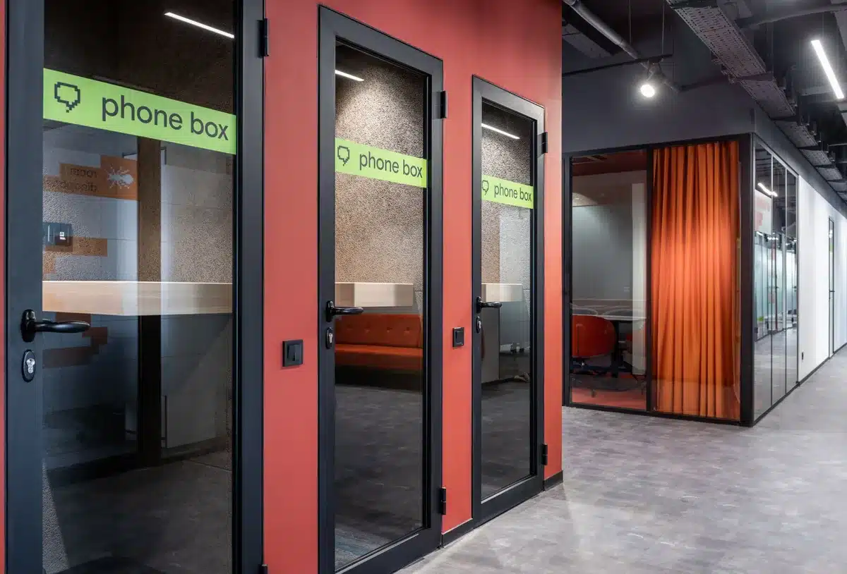 A sleek modern corporate office hallway with frosted glass doors and minimalist design, one door labeled with abstract AI iconography, subtle blue lighting suggesting innovation
