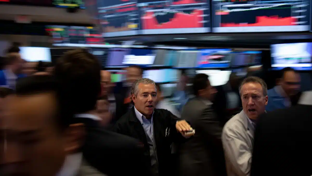 Stock market trading floor with red declining charts on multiple screens, traders in motion, urgent energy visible | stock market trading floor decline