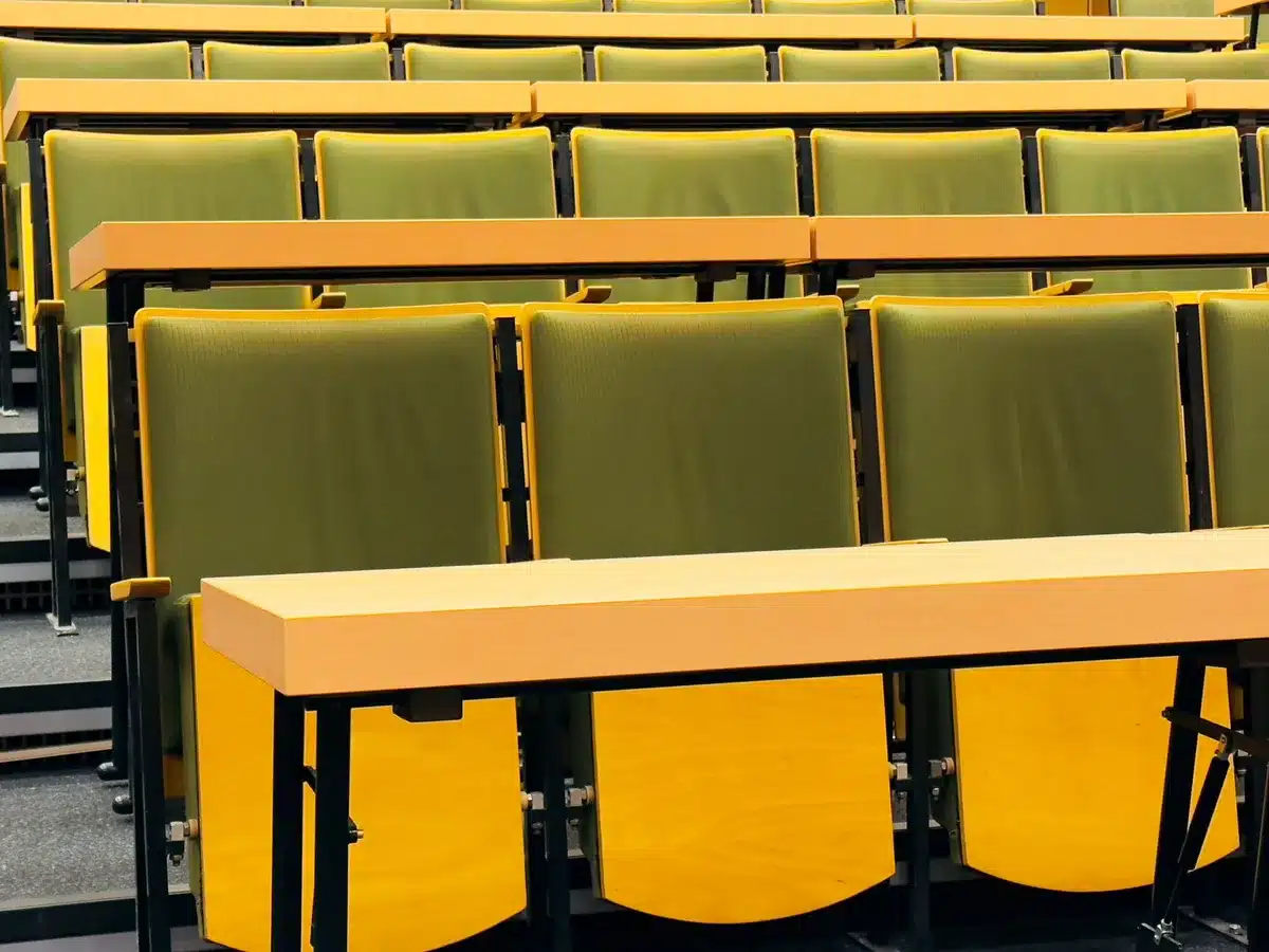 An empty lecture hall with desks and a podium, symbolizing academic freedom and the right to teach without censorship.