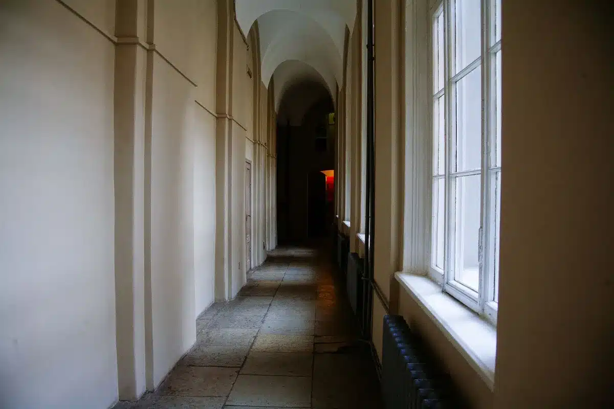 Capitol building interior with empty marble corridor and soft natural light filtering through windows