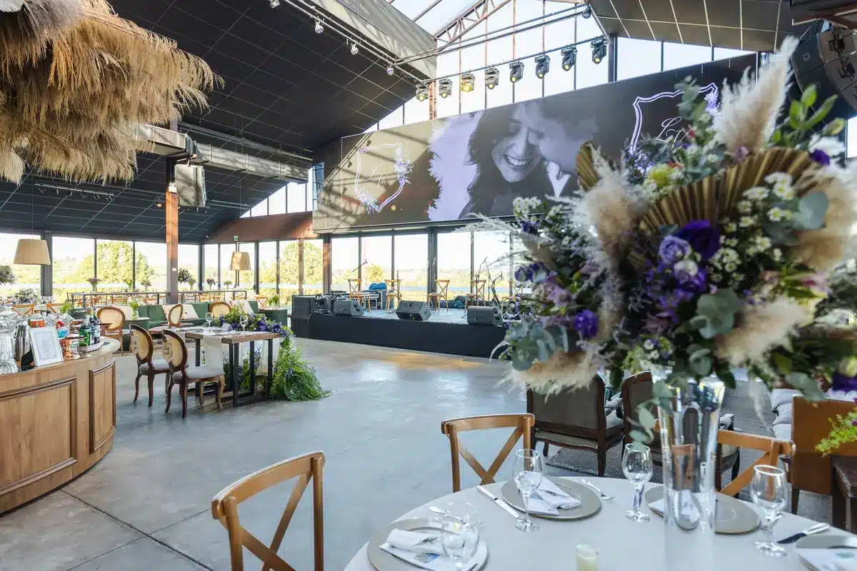 Award ceremony podium with microphone, empty seats facing the stage, formal table settings in soft focus