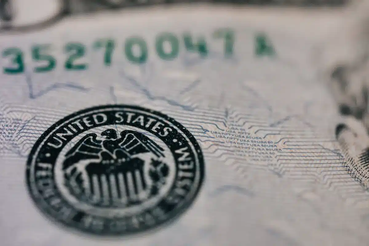 Stacks of money fading into shadow, with question marks floating above in soft focus, representing hidden donor identities and anonymous contributions
