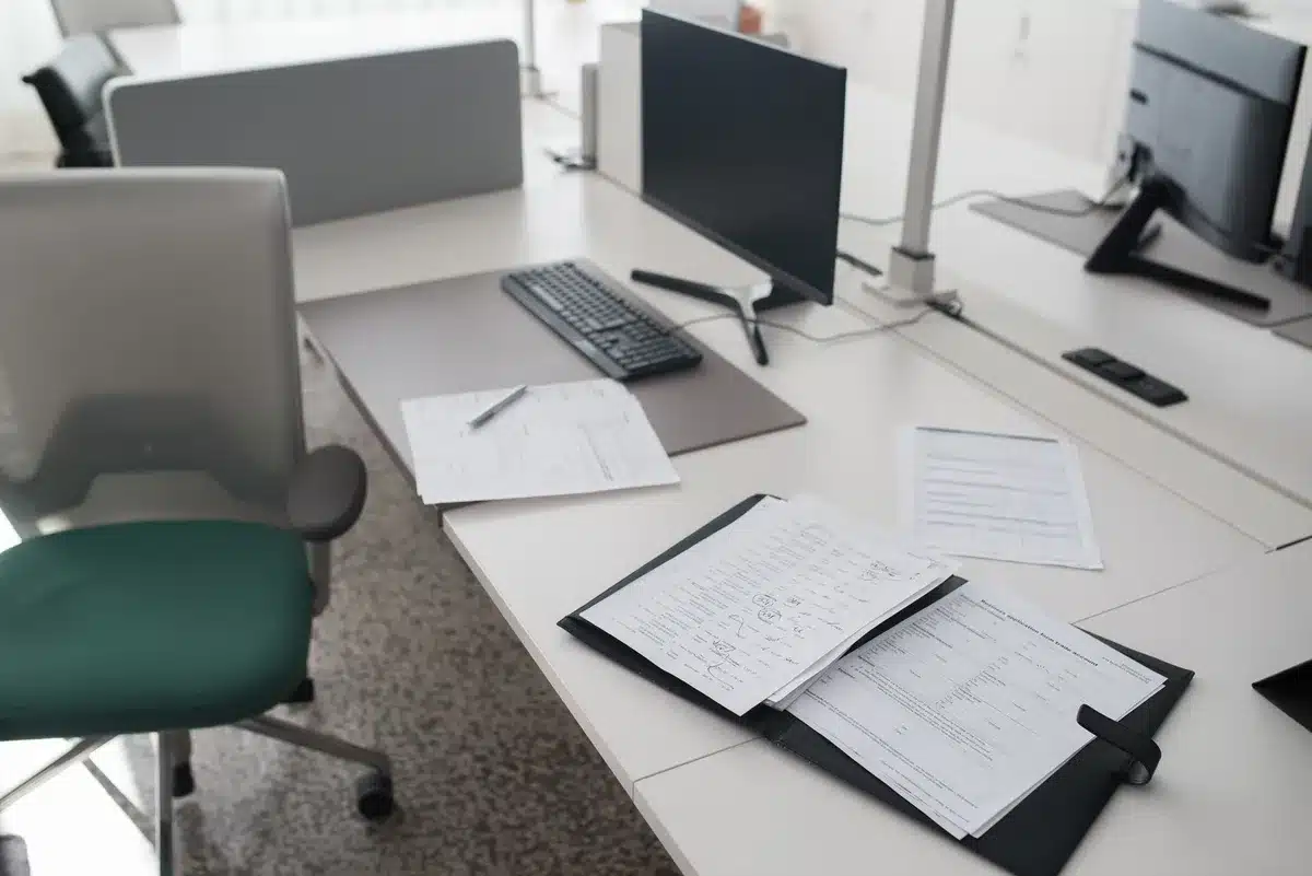 A formal government office interior with mahogany desk and official seals, papers and documents stacked neatly, a gavel resting nearby&mdash;the setting of federal law enforcement investigations and prosecutorial review.