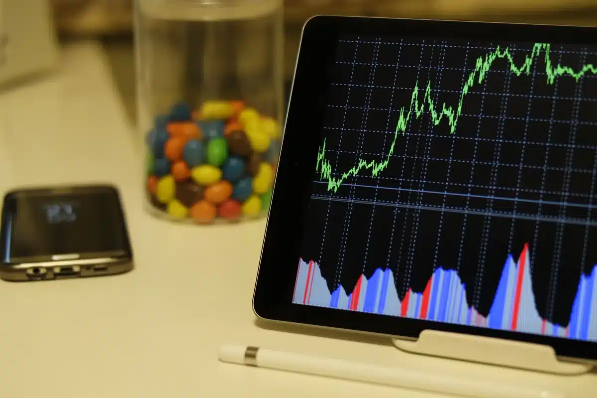 Glowing stock market ticker display with red and green numbers, a sharp divide showing gains and losses, financial data streaming across a dark screen