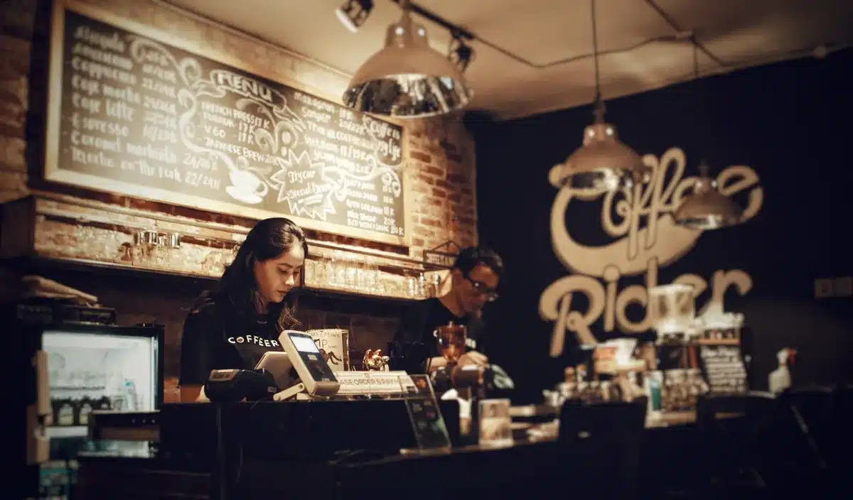 A Starbucks store interior with renovated seating areas, customers ordering at a counter with improved signage and faster service setup, warm lighting highlighting new design elements, staff in green aprons assisting customers, the "Back to Starbucks" initiative in action