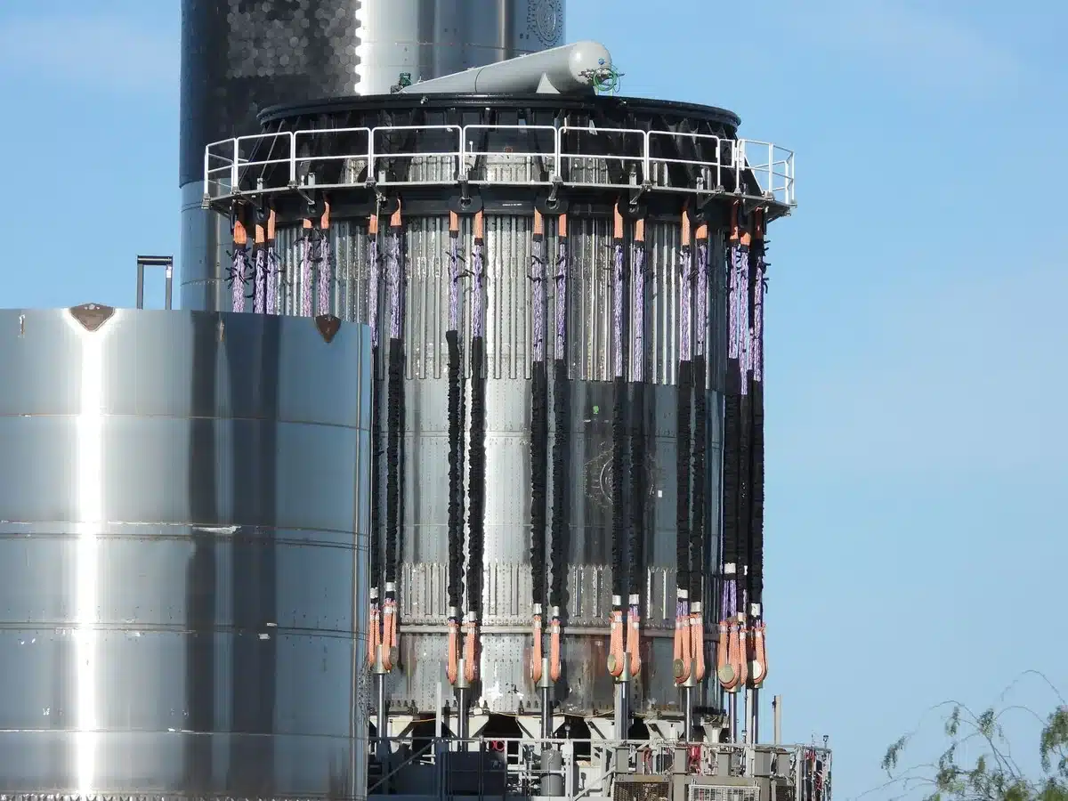 A spent Falcon 9 upper stage hurtling through deep space toward the Moon, solar panels and structural components visible against the black void, the lunar surface growing larger in the frame as impact approaches.