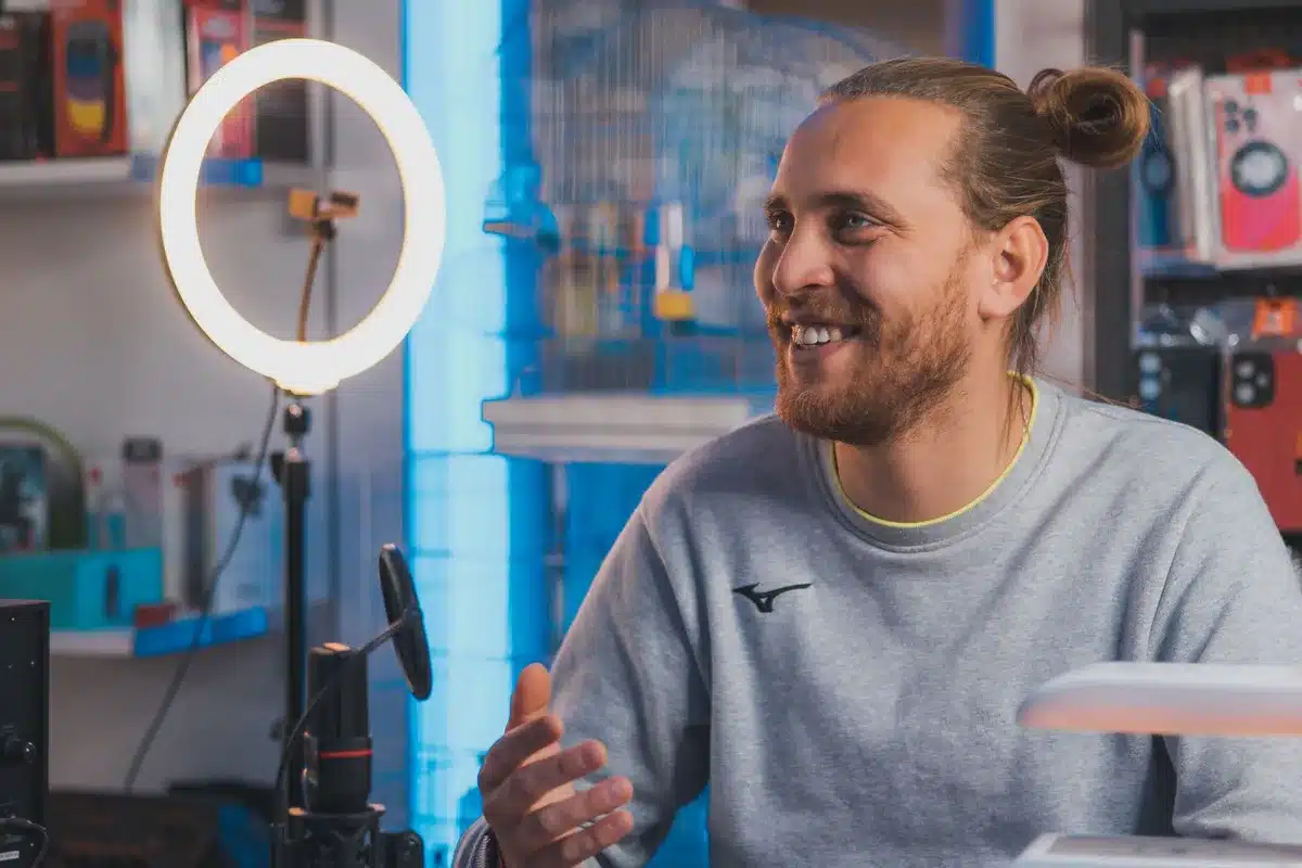 Social media influencers recording content in a studio setting, with ring lights and microphones visible, capturing the behind-the-scenes reality of modern political content creation