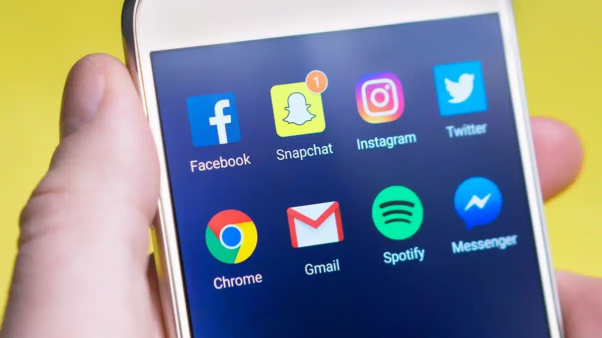 A smartphone screen displaying a social media feed with political content, showing engagement metrics and comments, illustrating how Gen Z voters consume political information