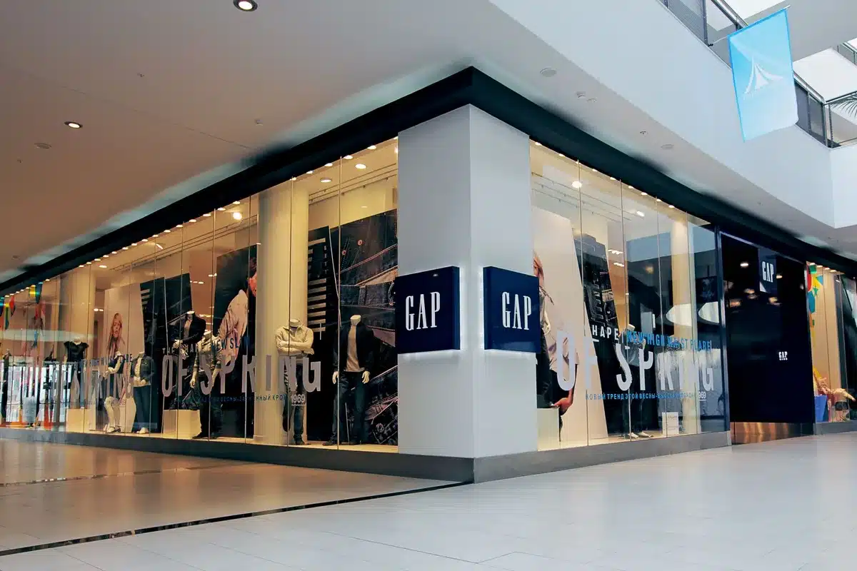 An empty modern retail storefront with glass doors and neutral lighting, featuring a minimalist architectural design and polished concrete flooring, waiting for brand transformation and new tenant activation.