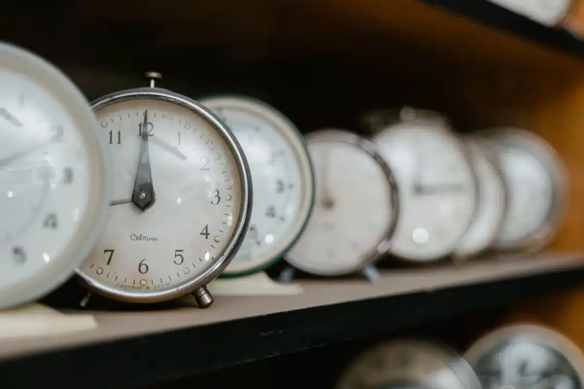 A clock face with hands approaching midnight, dim lighting, a sense of urgency, shallow depth of field