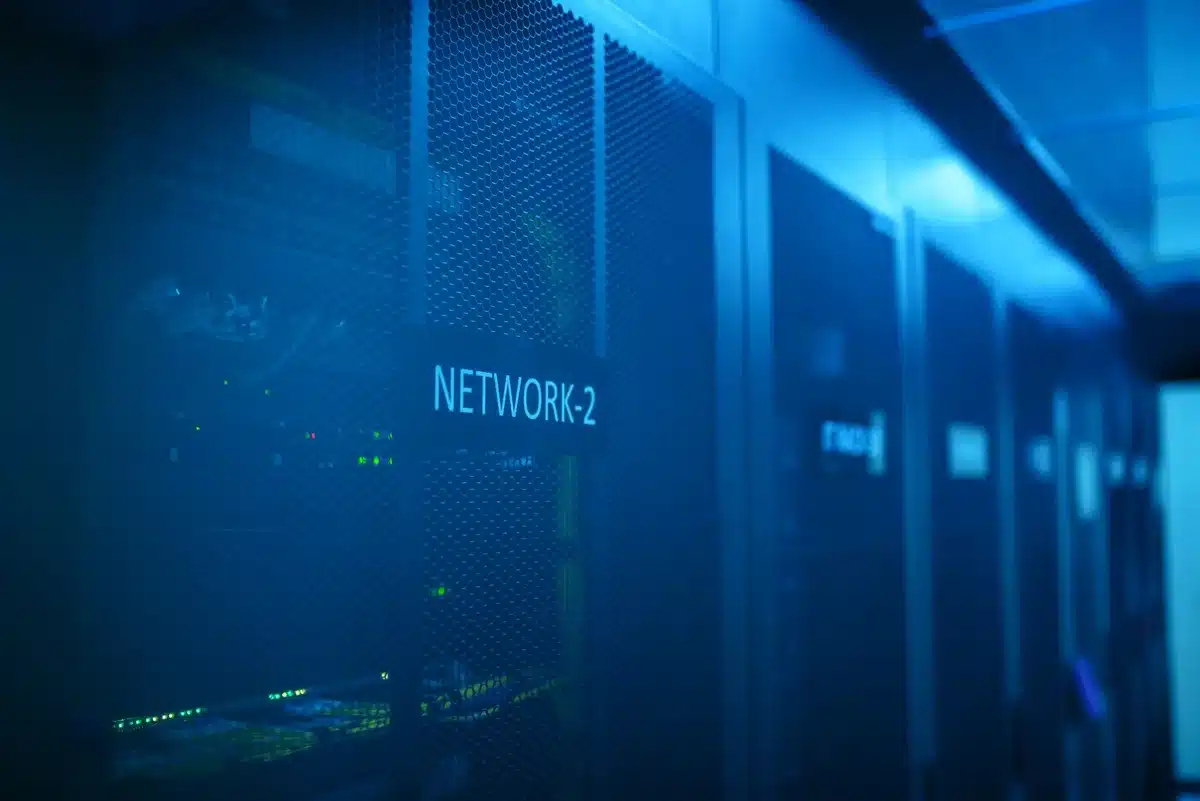 Data center server racks with glowing lights and cooling systems, emphasizing Intel chip technology powering AI infrastructure
