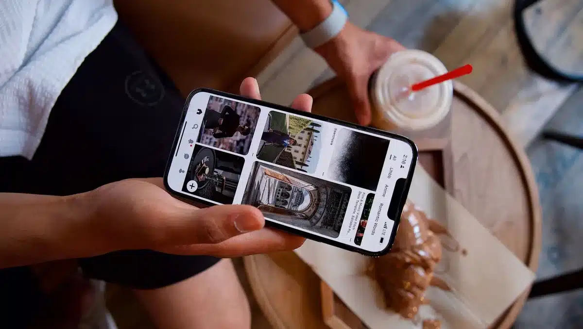 A smartphone displaying social media notifications and community messages from local followers, with warm natural lighting on the device screen