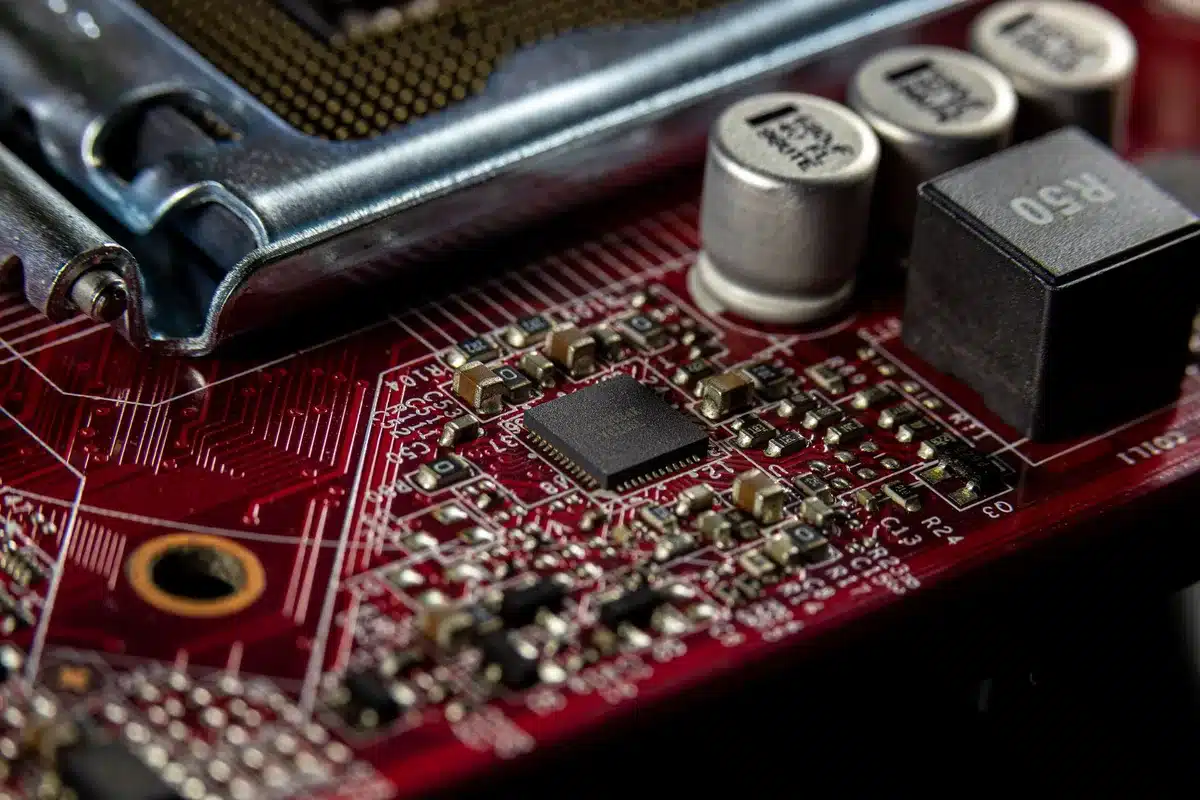 Semiconductor fabrication equipment on a factory floor, intricate machinery with blue and white components under industrial lighting, close-up of precision engineering
