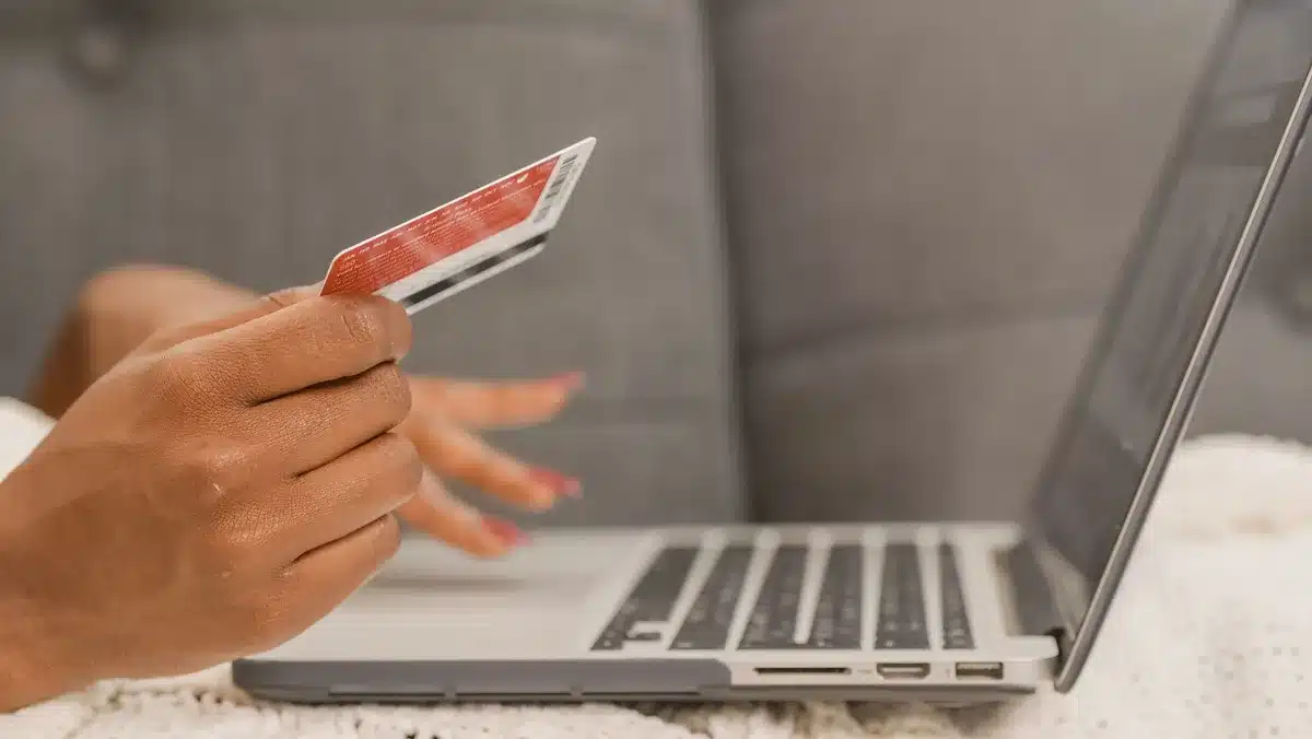 A debit card on a digital payment interface with financial data visualizations, symbolizing modern creator banking.