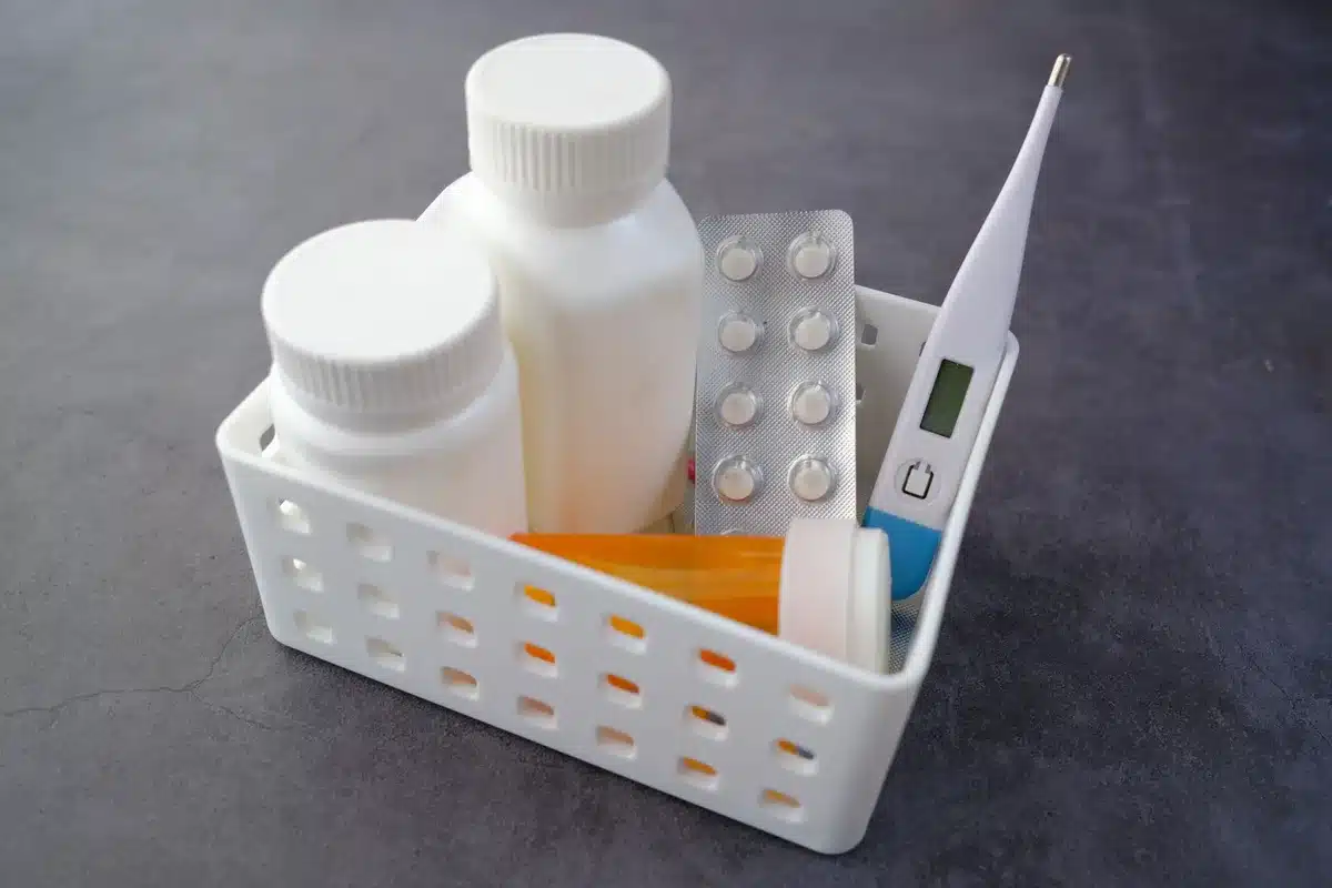 A pharmacy counter with shelves of prescription medication bottles, fluorescent lighting casting a clinical glow on rows of colorful pill containers, a blurred pharmacist in the background reaching for medications.