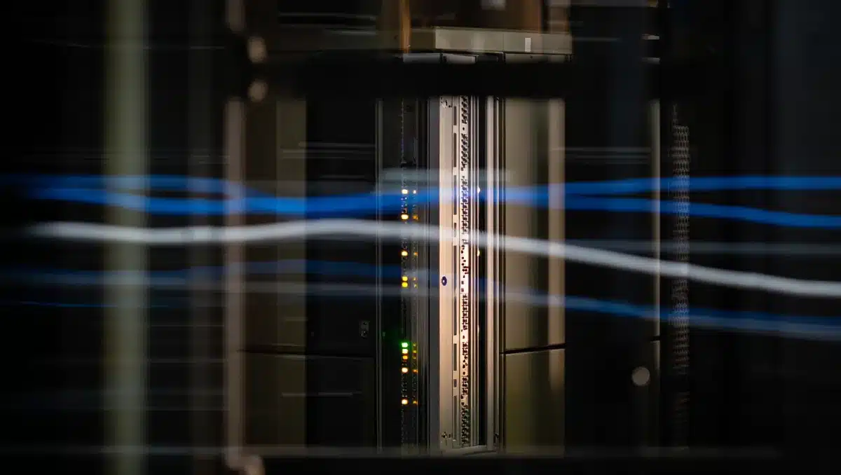 A glowing server rack in a dark data center, cooling lights reflecting off metallic infrastructure, abstract data streams flowing across the frame | server rack data center infrastructure
