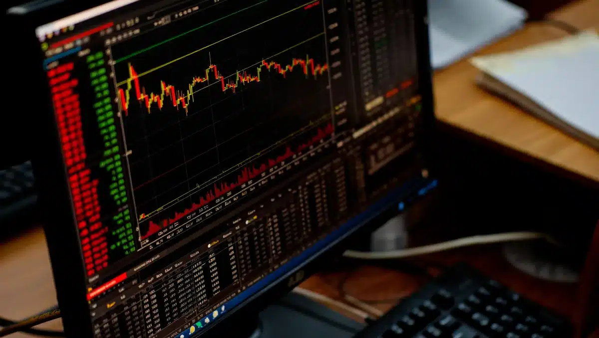 A stock market trading screen showing red candlesticks and declining charts | semiconductor stock decline visualization