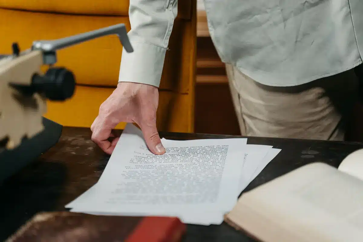 Formal constitution document on mahogany table, shallow depth of field, patriotic but neutral setting, no identifying marks