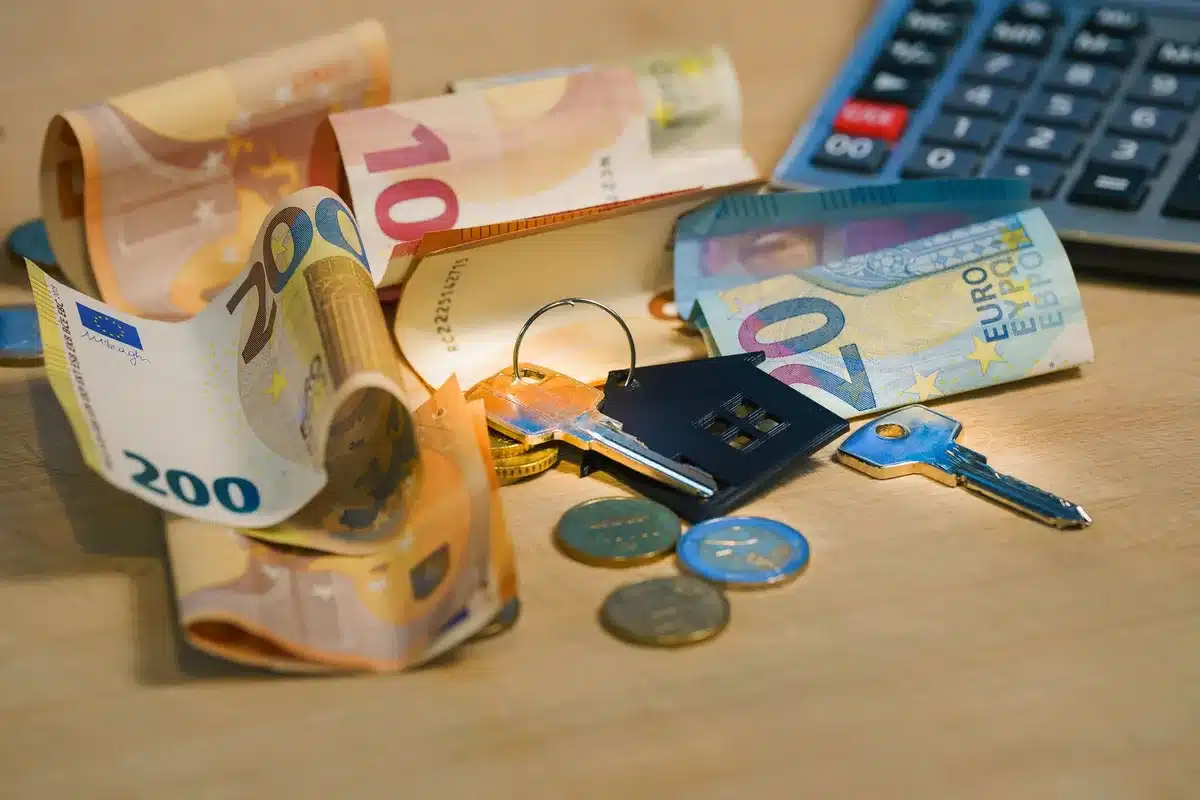 A residential mortgage document and calculator on a desk, papers scattered, reflecting the complexity of rate decisions