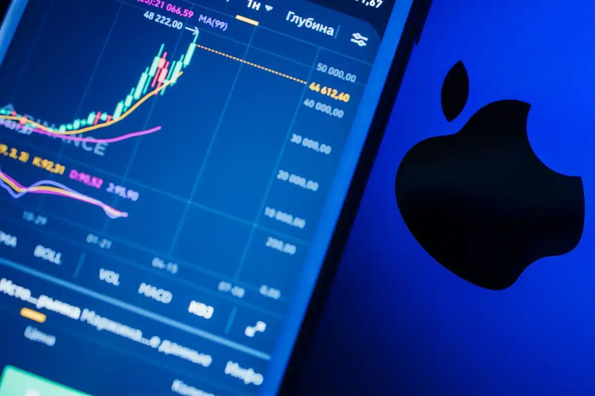 A glowing chart line climbing sharply upward on a dark screen, candlestick patterns in soft blue light, fingers hovering over a keyboard
