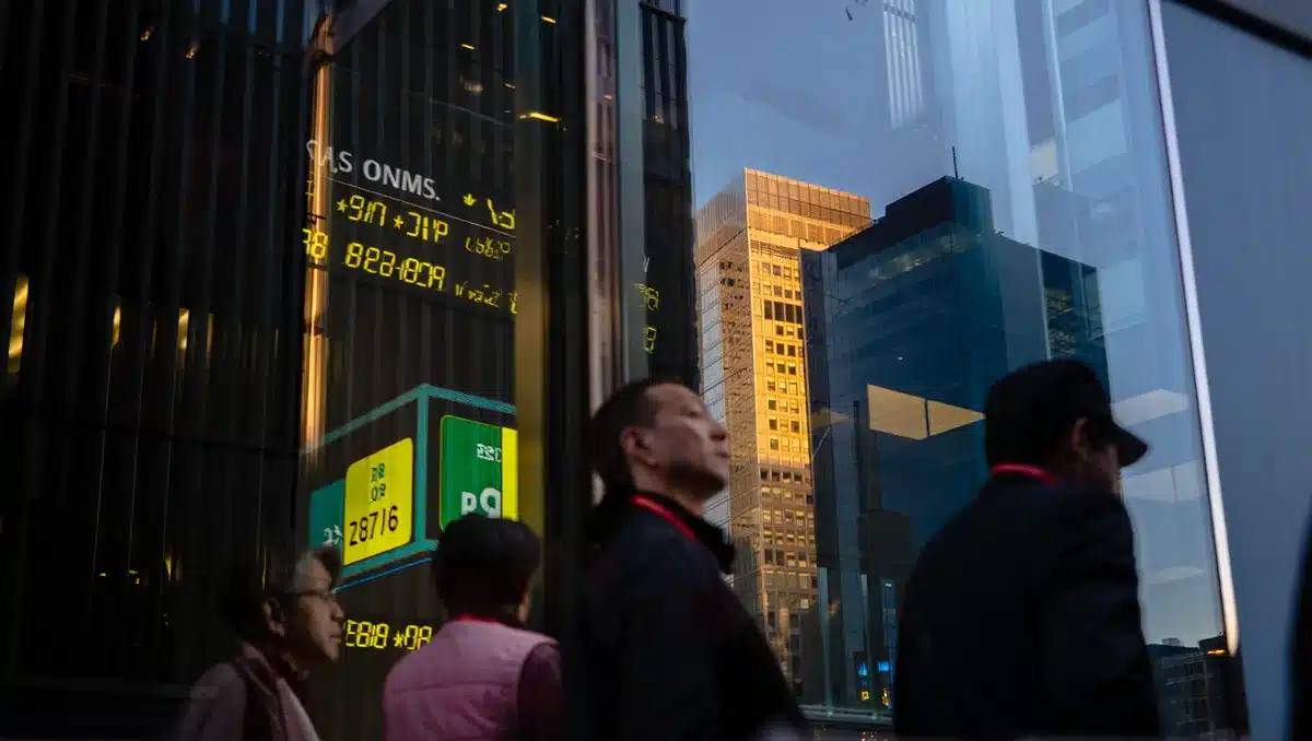 Financial district skyline at dusk with illuminated office towers and digital stock ticker screens reflecting in glass facades, conveying market uncertainty | stock market downturn financial technology