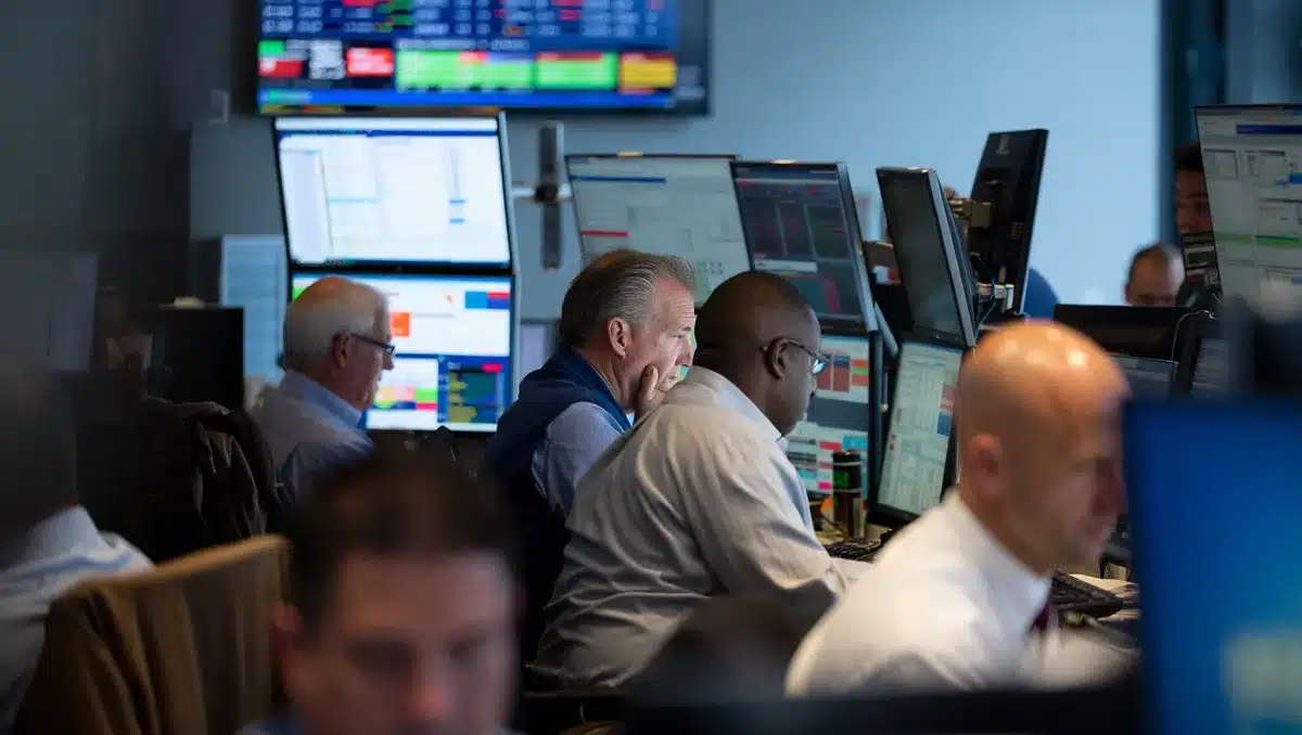 Stock market trading floor with multiple screens showing financial data and charts, traders at workstations monitoring live market activity | stock market trading floor screens