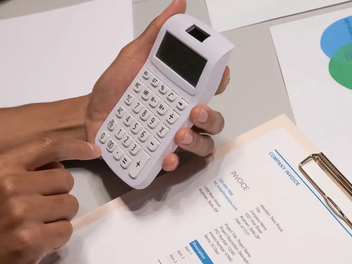A mortgage application form with a pen and calculator on a wooden desk, soft natural light illuminating the paperwork, suggesting financial planning and rate comparison.