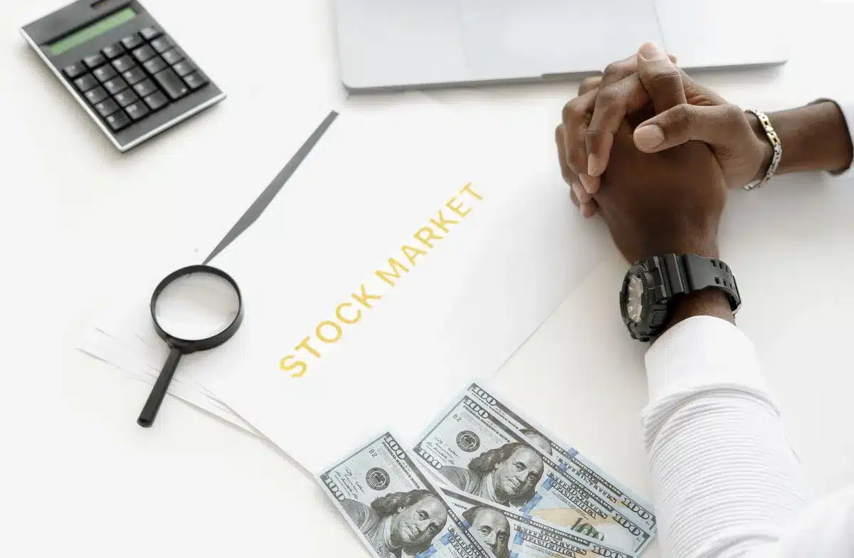 A sleek trading floor with glowing screens displaying rising stock charts and financial data, anonymous traders monitoring market positions, cool blue and green lighting, modern office environment with multiple monitors