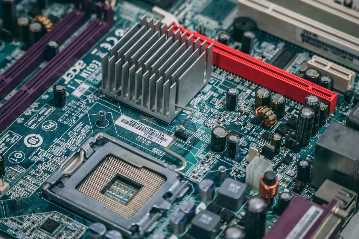 Semiconductor fabrication facility with rows of advanced memory chip manufacturing equipment under bright industrial lighting, focus on precision machinery and clean room environment