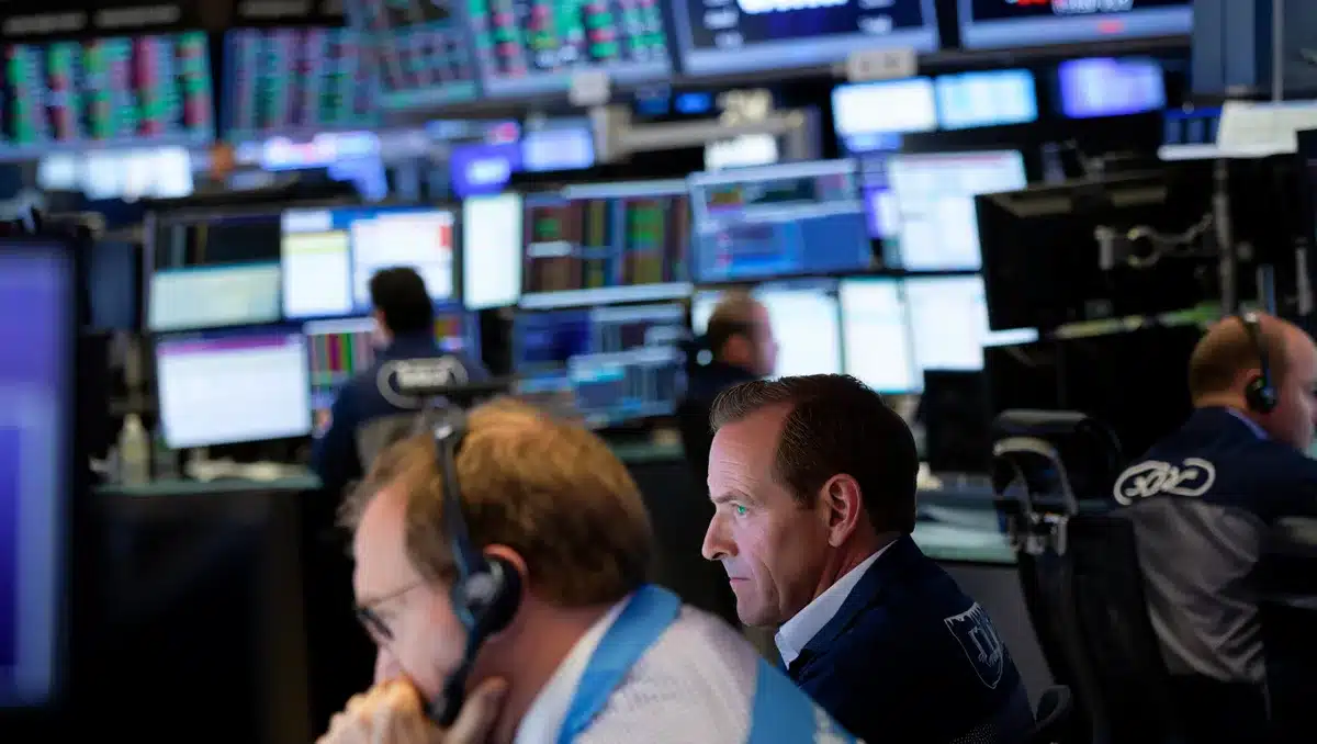 A sleek corporate trading floor with multiple screens displaying stock tickers and market data, traders monitoring real-time price movements, cool blue and green numbers glowing on dark backgrounds | stock market trading floor