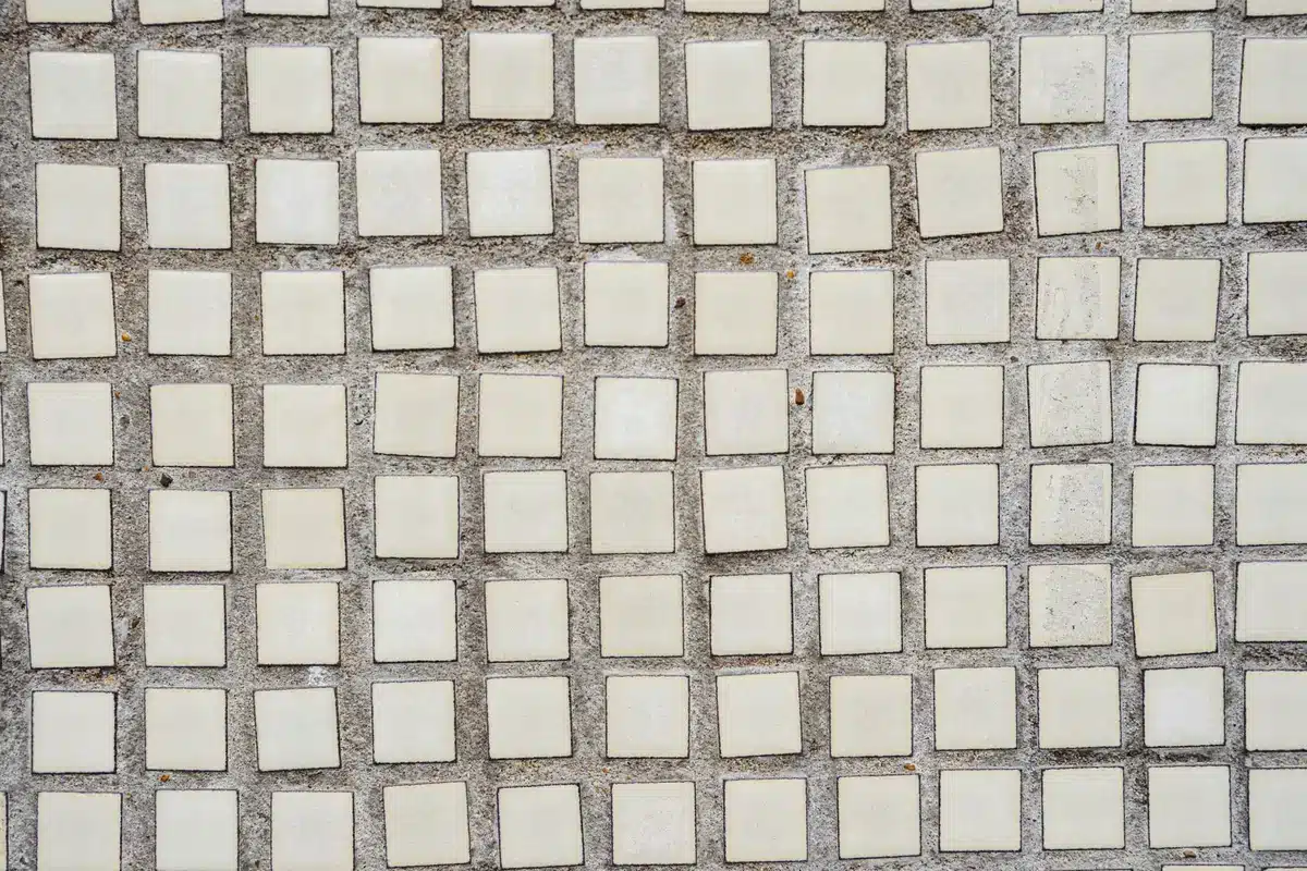 Starship upper stage heat shield with ceramic tiles in close detail, hexagonal pattern catching light, tiles showing wear or testing marks