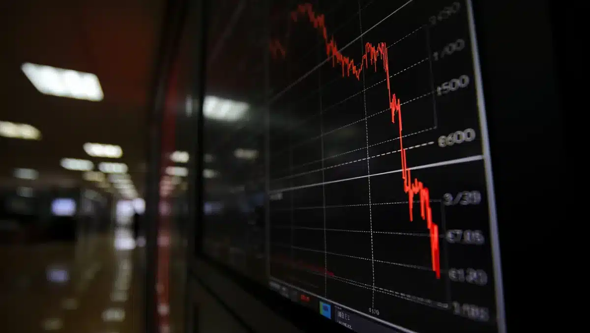 Stock market display showing red decline arrows and falling price charts on a dark screen, reflecting investor losses and market downturn | stock market decline display
