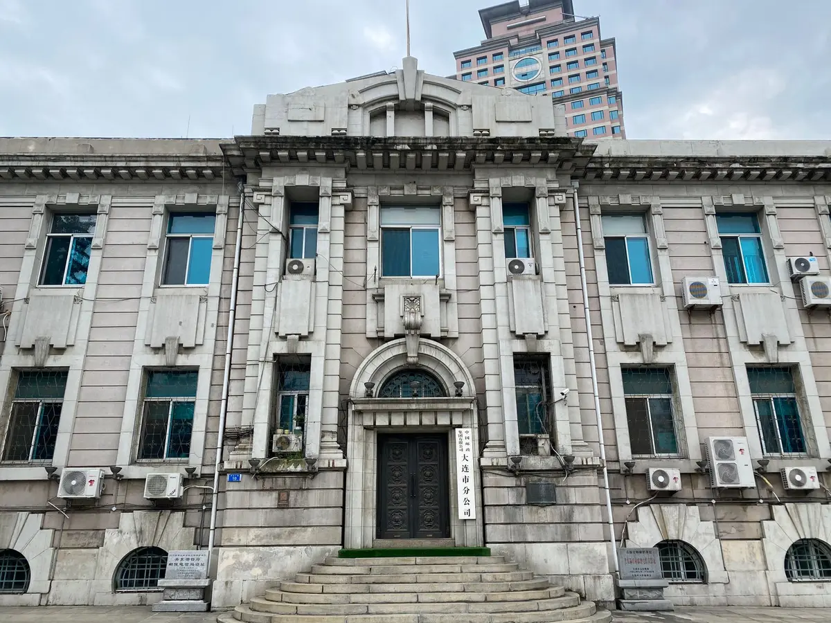 A government office building entrance with official signage, natural daylight, professional setting