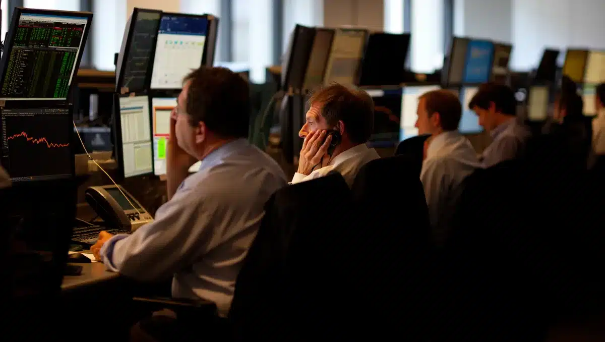 A stock market trading floor with glowing screens and data streams, traders monitoring rising indices, green numbers dominating the display, morning sunlight through tall windows | stock market futures trading floor