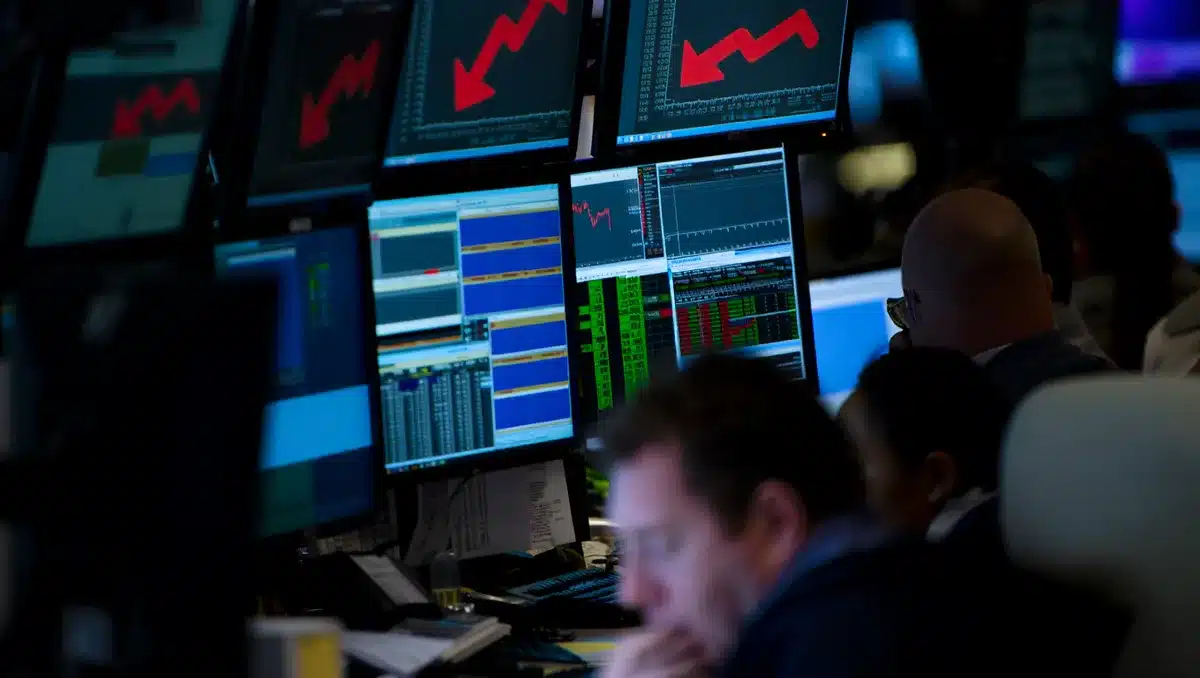 A stock market ticker displaying red decline arrows and financial data, dimly lit computer screens reflecting falling numbers, a concerned investor silhouette against glowing charts | stock market decline visualization