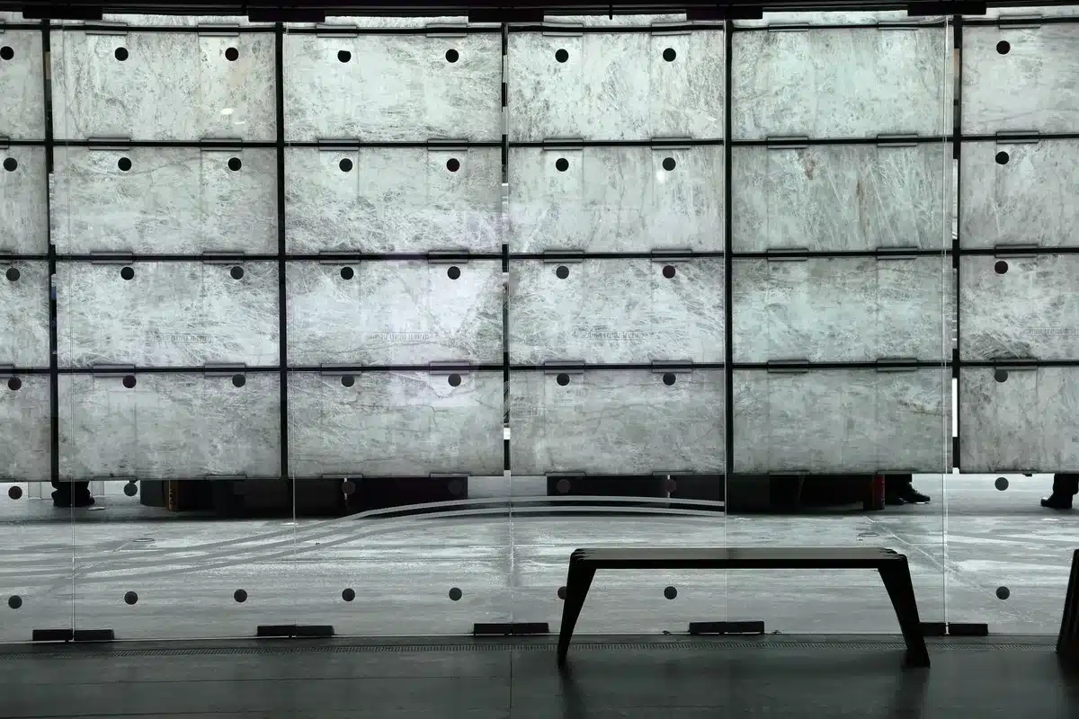 A federal courthouse building interior with empty courtroom benches and a judge's bench in shadow, symbolizing a dormant legal process now activated