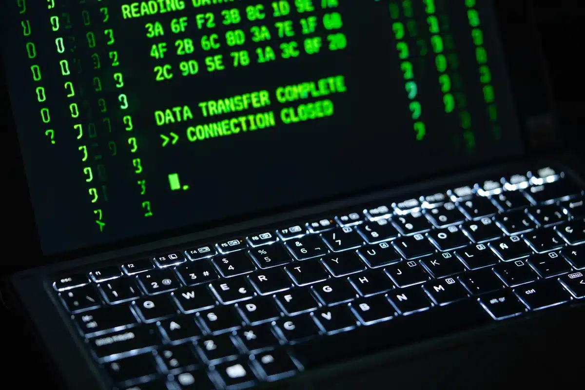 A federal cybersecurity operations center with multiple screens displaying threat monitoring dashboards and real-time election infrastructure status updates, staffed by analysts at workstations.