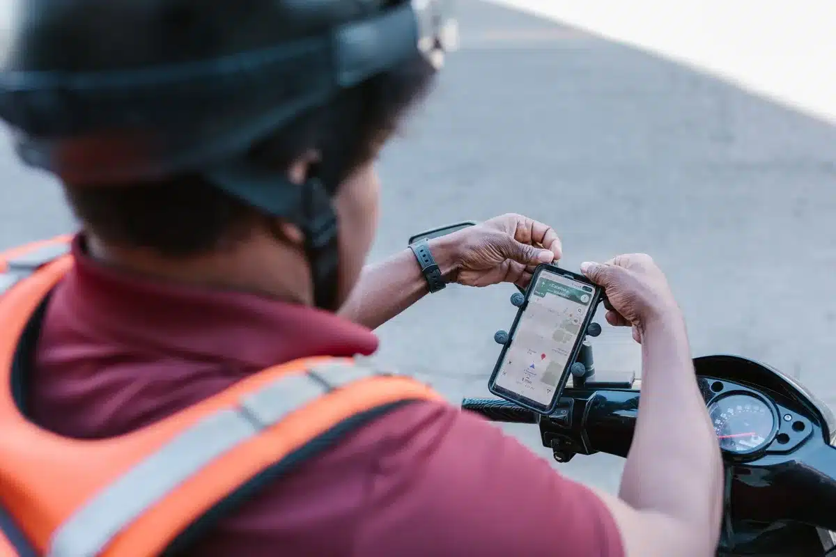 A split-screen showing Uber's and Delivery Hero's brand logos and app interfaces on mobile devices, symbolizing platform integration and merger.