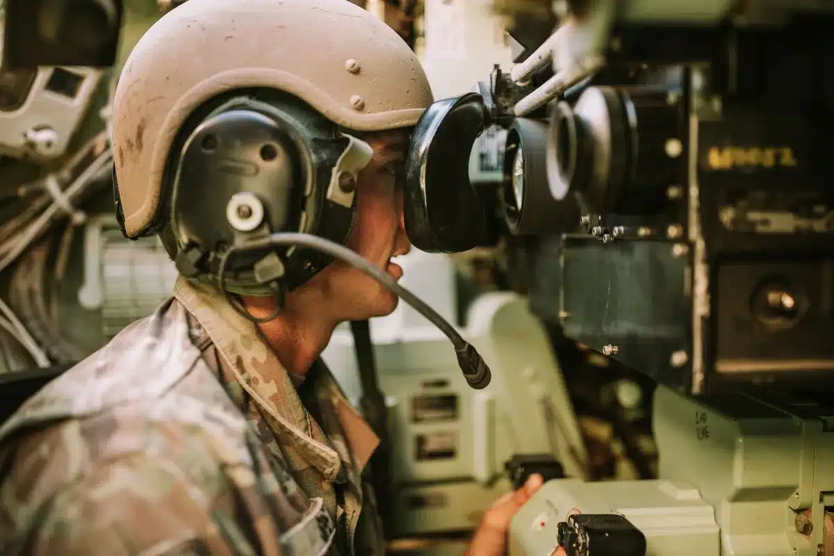 A radar screen display showing tactical data and target tracks in a military operations center, with operators monitoring aircraft positions in real time.