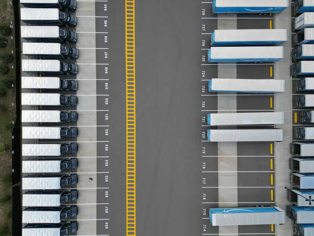 A modern supply chain operations center with digital displays showing real-time package tracking and network metrics.