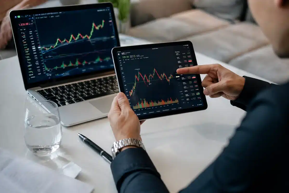 Stock market screens displaying rising yield numbers and red-downward arrow indicators, financial data streaming