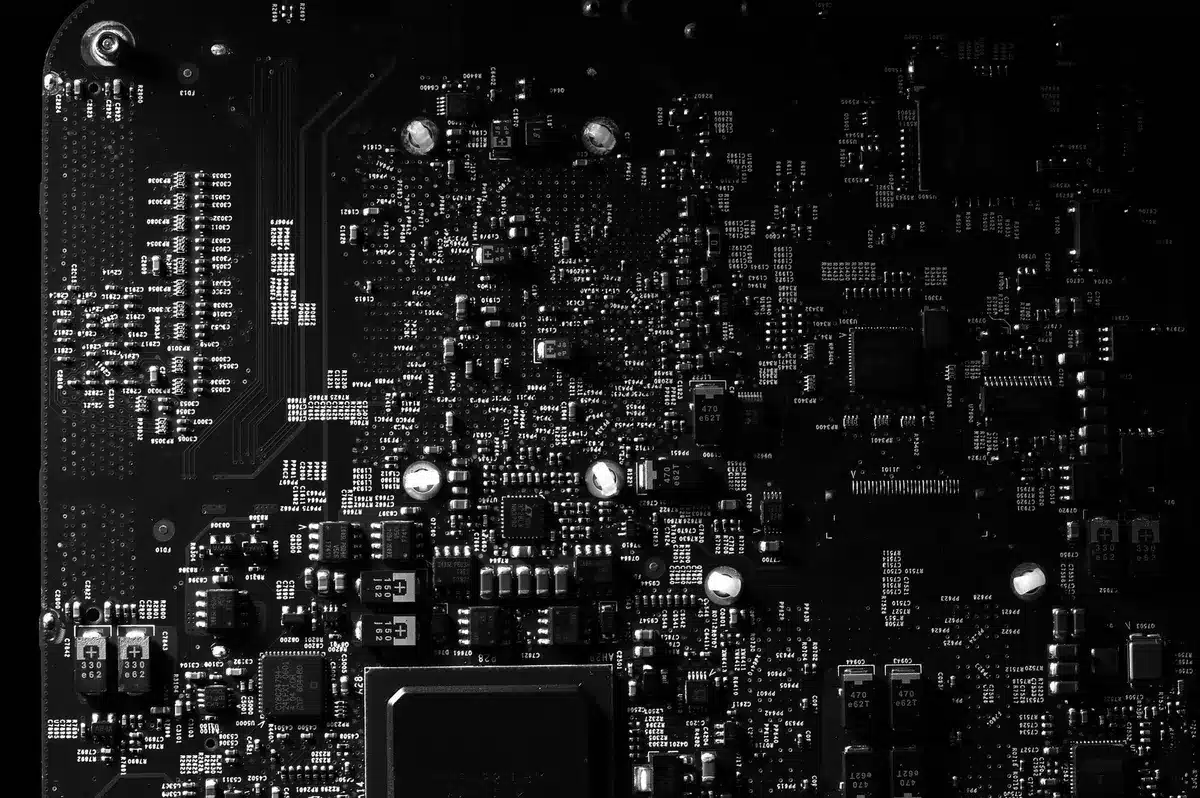 A glowing circuit board with interconnected pathways and nodes lit up in blue and amber, representing signal flow and data connectivity at a microscopic level