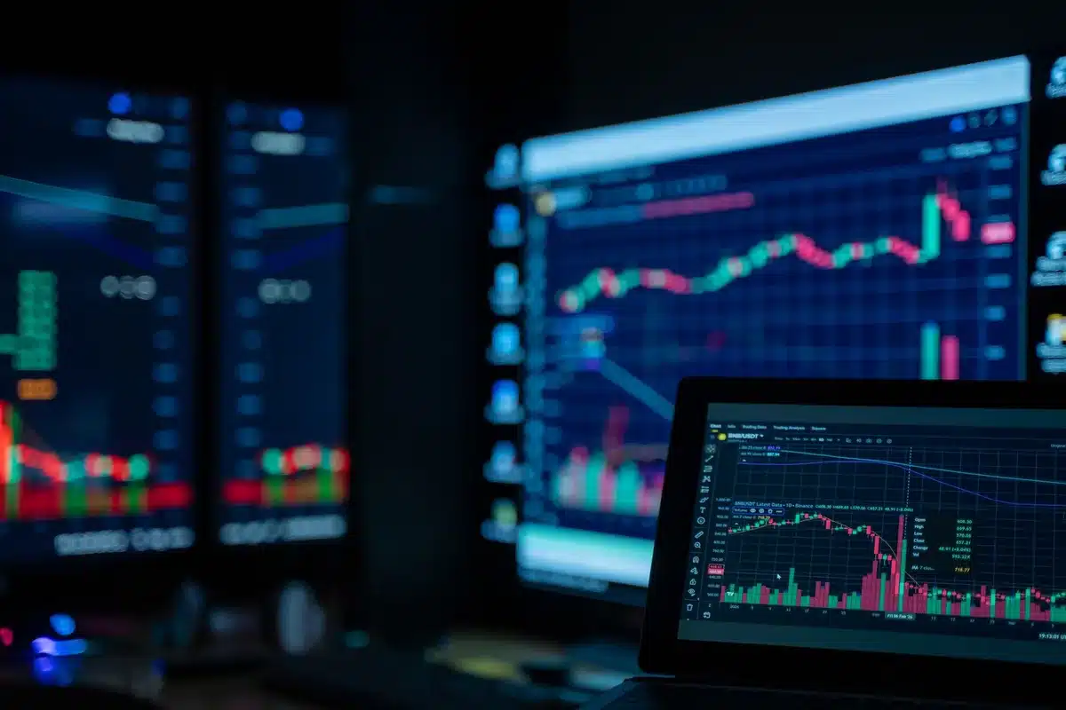 A stock exchange trading floor during volatile market hours, with digital screens displaying red numbers and declining charts, traders in motion, tension visible in the ambient lighting