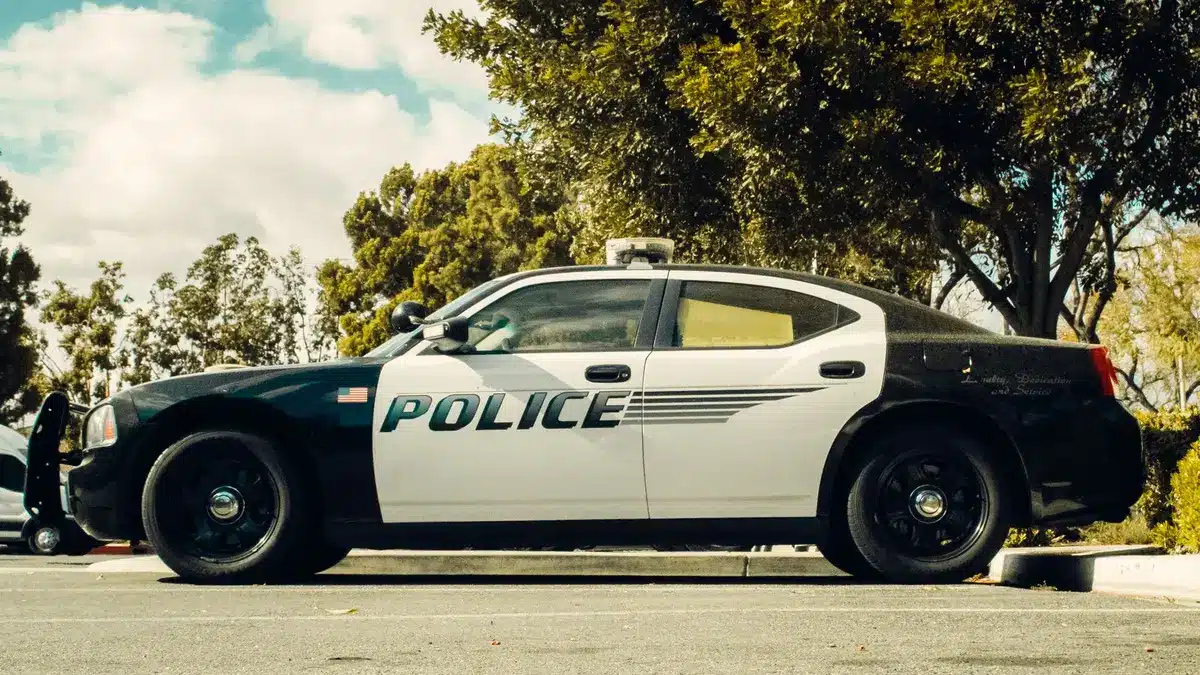 DOT regulations document on desk with calculator and pen, formal government building in background
