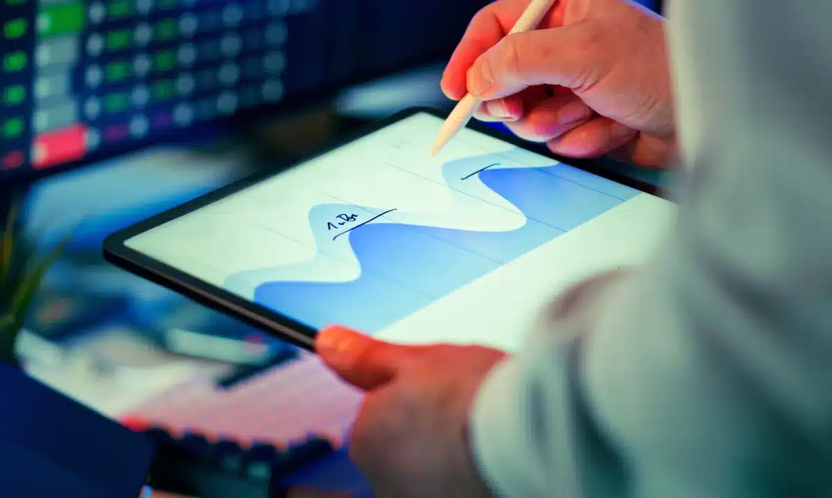 A corporate earnings report displayed on a financial screen with stock ticker symbols and growth charts visible, reflecting anticipation before quarterly results announcement