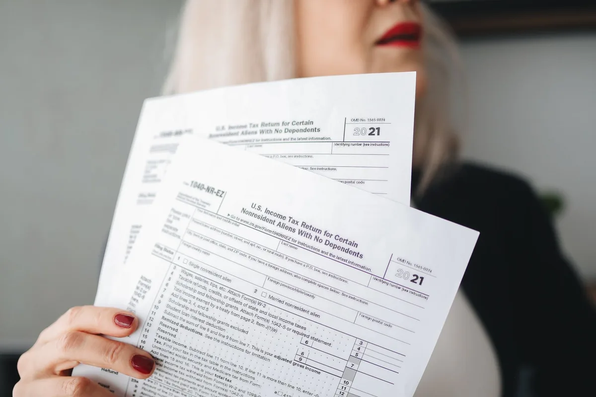 Campaign finance documents and donation records spread on a desk with calculator and pen