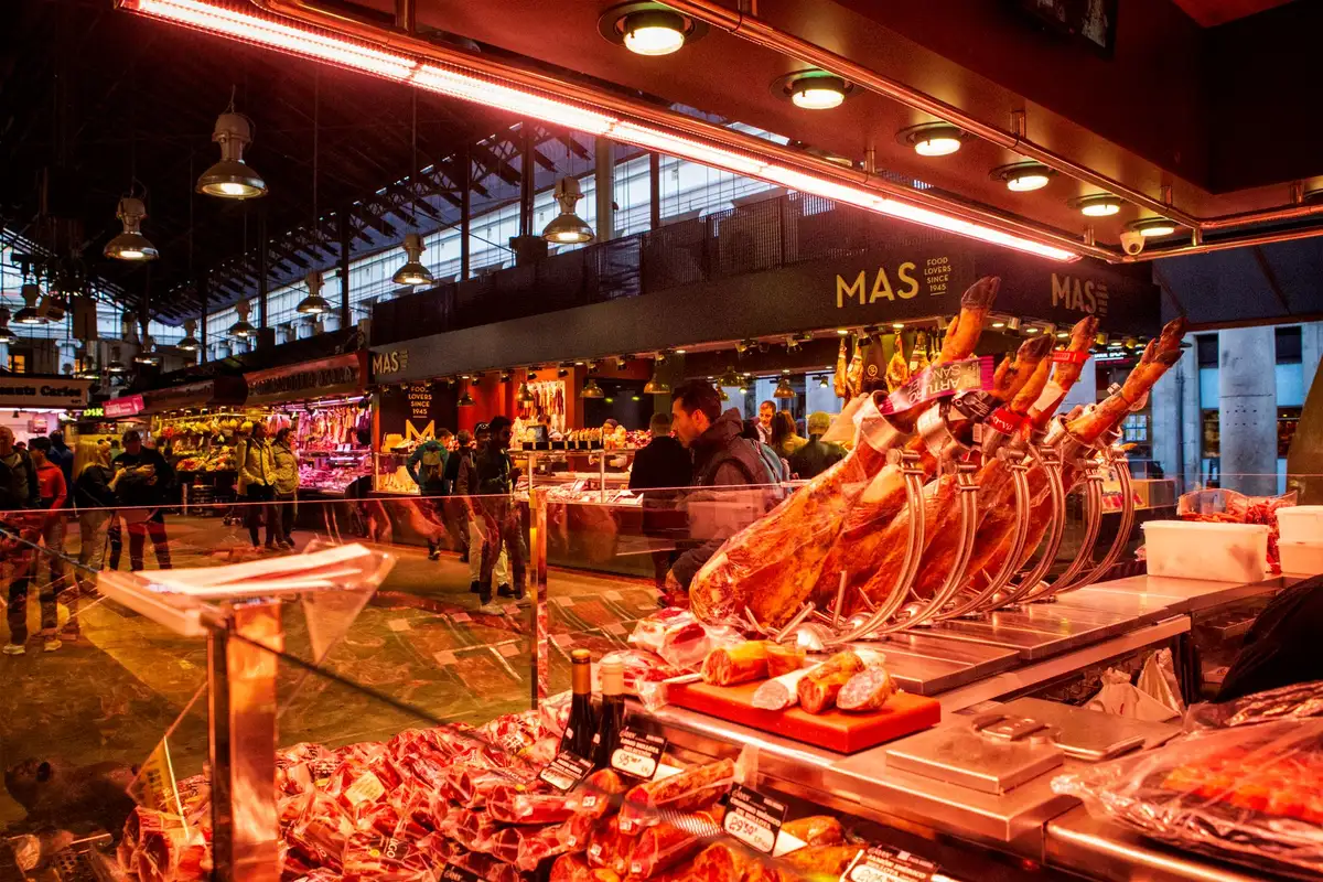 A refrigerated display case with empty shelves where packaged beef would typically be stocked, with price tags visible but no product, under store lighting