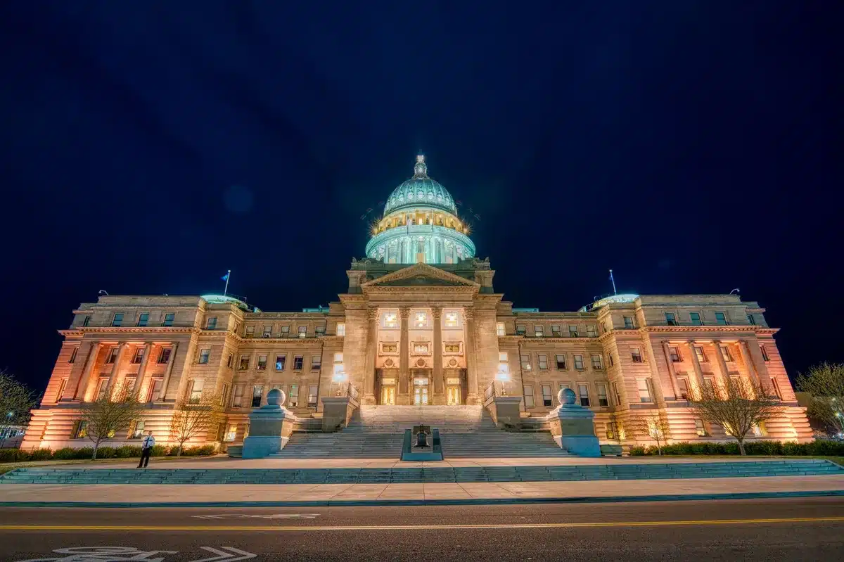 Michigan state capitol building exterior with state seal visible, autumn trees, civic architecture