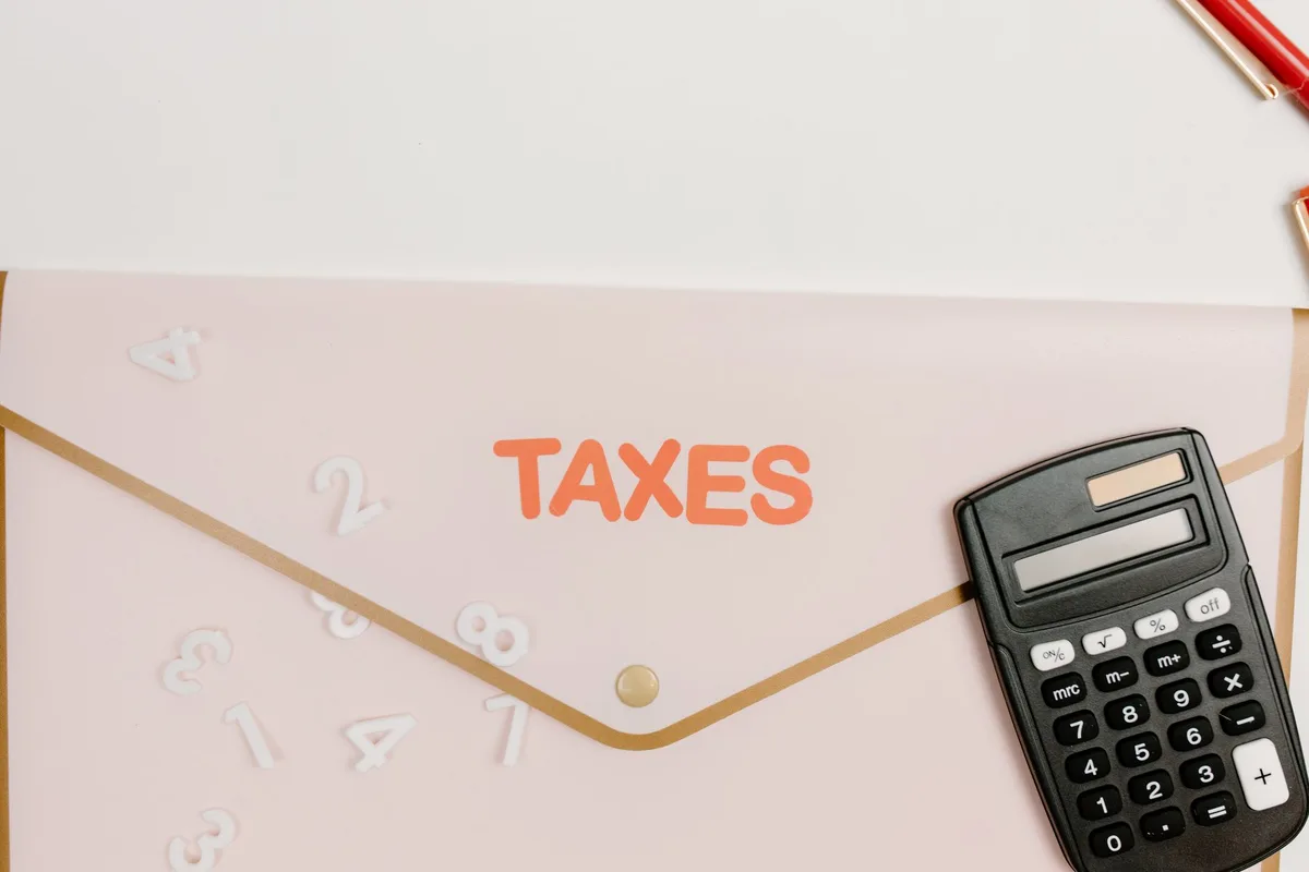 A simple tax form on a desk with a calculator and pen, representing federal income tax filing for lower-income households.